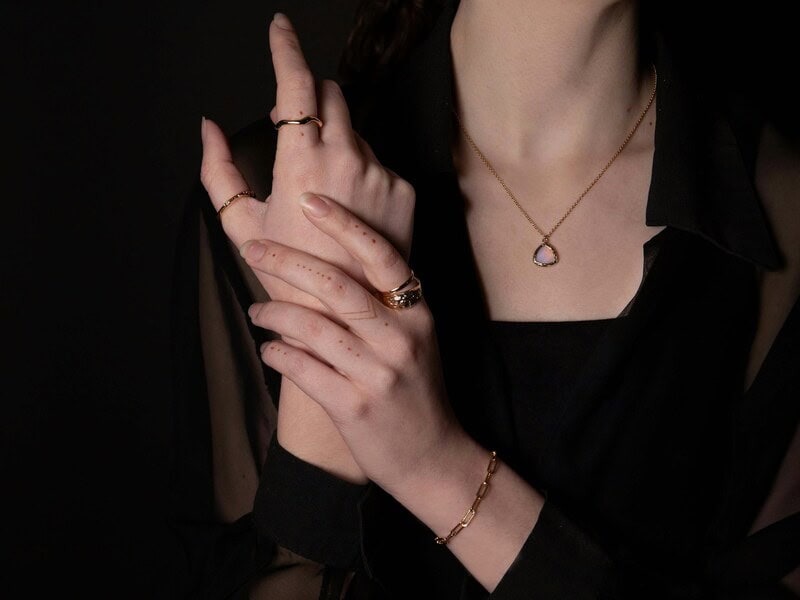 woman dressed in black wearing jewelry